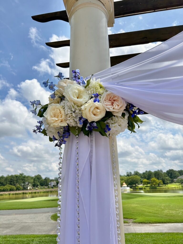 Pergola design, floral cuff tie backs for a wedding at the pergola of The Dominion Club. Pergola wedding flowers by Ethos Floral Events