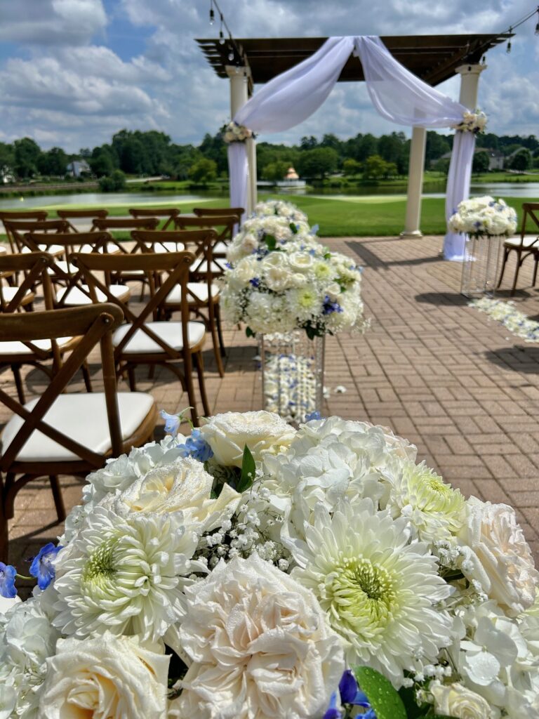 White wedding flowers on stand as aisle markers at the Dominion Club in Glen Allen, VA. Floral design by Ethos Floral Events.
