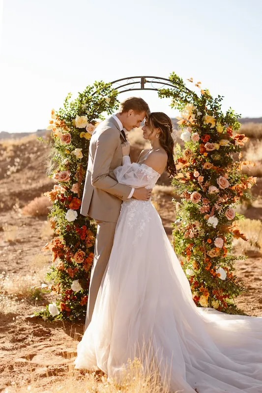 Broken arch of wedding ceremony flowers in the desert in Utah.